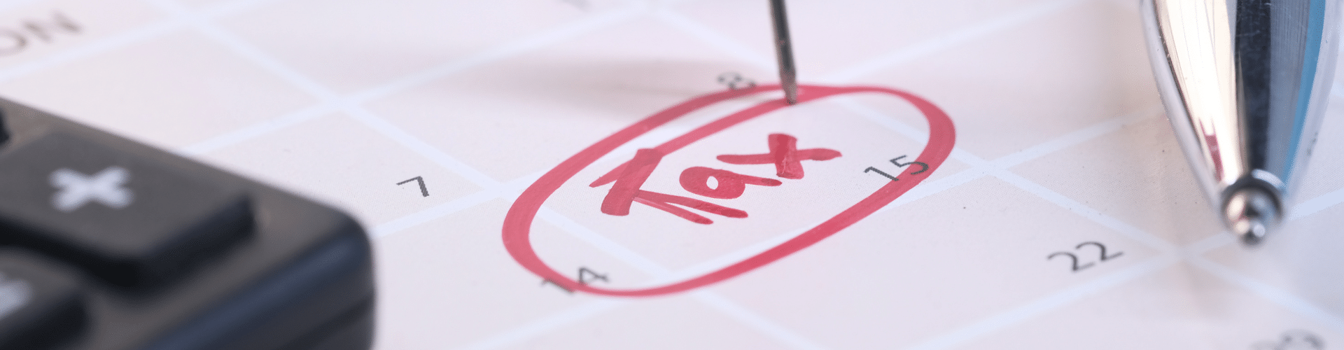 Close-up of a calendar with the word 'Tax' circled in red ink, marked with a pin, symbolizing a critical tax deadline or planning date.